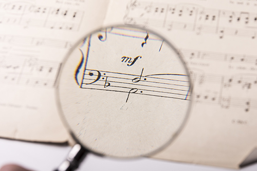 magnifying glass over a musical score