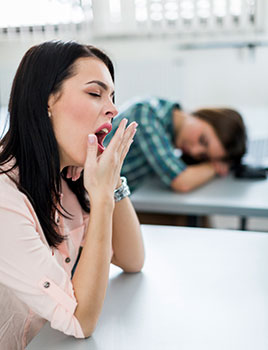 A girl yawning in class