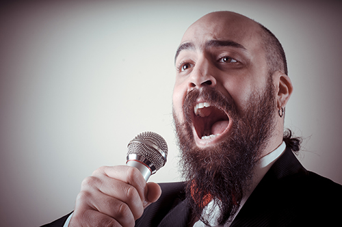 man singing into microphone