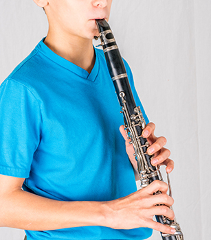 boy playing the clarinet