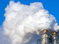 white clouds coming out of a factory